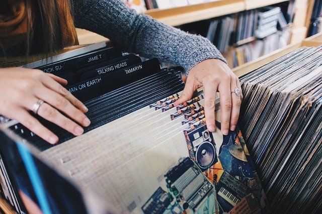 Targeted website development to help connect customers with the right product, shown by person browsing through record bin. 